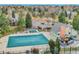 Aerial view of a large covered community pool, adjacent to other community amenities and residential homes at 8166 E Phillips Ave, Centennial, CO 80112