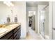 Bathroom featuring double sink vanity, walk-in closet and walk-in shower at 1849 S Helena St, Aurora, CO 80017