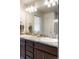 Bathroom featuring granite countertop double sink vanity with two faucets and a large mirror at 1849 S Helena St, Aurora, CO 80017