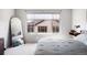 Bright bedroom with a large window, full-length mirror and comfortable bed at 1849 S Helena St, Aurora, CO 80017