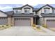Inviting exterior of townhome with a two-car garage and stone accents at 1849 S Helena St, Aurora, CO 80017