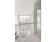 Bright hallway featuring white railing overlooking the floor below with carpeted floor at 1849 S Helena St, Aurora, CO 80017