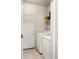 Bright laundry room featuring white front-load washer and dryer with white door at 1849 S Helena St, Aurora, CO 80017