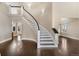 Elegant curved staircase with dark wood floors at 7181 Longview Dr, Niwot, CO 80503