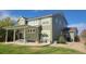 Exterior view of the backyard showcasing a stone patio with outdoor furniture and a well-kept lawn at 6892 Turnstone Ave, Castle Rock, CO 80104