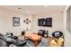 Basement living area featuring a large TV, dark sofa, and fun decor at 6892 Turnstone Ave, Castle Rock, CO 80104