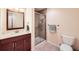 Bathroom featuring a tiled shower, wood vanity, and a large mirror at 6892 Turnstone Ave, Castle Rock, CO 80104