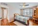 Bedroom with light pink walls, ceiling fan and wood floors features a sunny window and desk at 6892 Turnstone Ave, Castle Rock, CO 80104