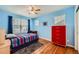 Cozy bedroom with hardwood floors, a ceiling fan, and natural light from window with blinds at 6892 Turnstone Ave, Castle Rock, CO 80104