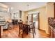 Cozy dining area with hardwood floors, bright natural light, and views of the fireplace at 6892 Turnstone Ave, Castle Rock, CO 80104