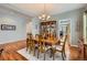 Traditional dining room featuring a wooden table with seating for six, chandelier, and hardwood flooring at 6892 Turnstone Ave, Castle Rock, CO 80104