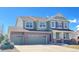 Inviting two-story home featuring a brick facade and a spacious three-car garage in a Gathering-friendly neighborhood at 6892 Turnstone Ave, Castle Rock, CO 80104
