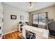 Well-lit home office with large window, modern desk, and hardwood floors, ideal for remote work or study at 6892 Turnstone Ave, Castle Rock, CO 80104