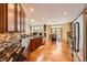 Open kitchen featuring stainless appliances, hardwood floors, and modern backsplash at 6892 Turnstone Ave, Castle Rock, CO 80104