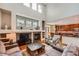 Elegant living room featuring a fireplace, vaulted ceiling, and an open floor plan, perfect for entertaining guests at 6892 Turnstone Ave, Castle Rock, CO 80104
