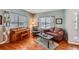 Cozy living room with hardwood floors, natural light, and comfortable seating at 6892 Turnstone Ave, Castle Rock, CO 80104