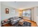 Cozy living room with a gray sofa, hardwood floors, and natural light from a window at 6892 Turnstone Ave, Castle Rock, CO 80104