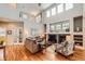 Inviting living room with hardwood floors, cozy sofa, fireplace, and tall ceilings, creating a warm and inviting atmosphere at 6892 Turnstone Ave, Castle Rock, CO 80104