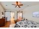 Bedroom featuring hardwood floors and a barn door leading to the ensuite bathroom at 6892 Turnstone Ave, Castle Rock, CO 80104
