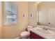 Simple powder room featuring a window, vanity, and toilet at 6892 Turnstone Ave, Castle Rock, CO 80104