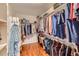 Spacious walk-in closet featuring an organized storage system with rods and shelves at 6892 Turnstone Ave, Castle Rock, CO 80104