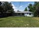 Expansive backyard featuring a well-manicured lawn and covered patio area at 1032 Geneva, Aurora, CO 80010
