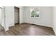 Bedroom with sliding closet doors, large window and wood-look floors at 1032 Geneva, Aurora, CO 80010