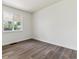 Bright bedroom with large window, grey wood-look flooring and neutral walls at 1032 Geneva, Aurora, CO 80010