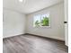 Bright bedroom with large window, grey wood-look flooring and neutral walls at 1032 Geneva, Aurora, CO 80010