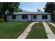 Charming single-story home with a well-maintained lawn and a concrete driveway at 1032 Geneva, Aurora, CO 80010