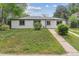 Charming single-story home with white siding, black trim, and a well-manicured green lawn at 1032 Geneva, Aurora, CO 80010
