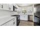 Modern kitchen showcasing white cabinets, stainless steel appliances, and stylish backsplash at 1032 Geneva, Aurora, CO 80010