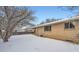Brick house with a backyard covered in snow at 12700 E Kentucky Pl, Aurora, CO 80012