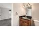 Comfortable bathroom displaying a wooden vanity with a dark countertop and light fixture at 12700 E Kentucky Pl, Aurora, CO 80012