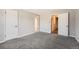 Large bedroom with gray carpet and closets on two walls at 12700 E Kentucky Pl, Aurora, CO 80012