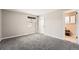 Bedroom with neutral paint, carpet, window, and a door to the bathroom at 12700 E Kentucky Pl, Aurora, CO 80012