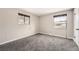 Bright bedroom featuring plush carpet, two windows, and neutral paint at 12700 E Kentucky Pl, Aurora, CO 80012