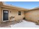 Home exterior with a black door, brick wall, and convenient shoe rack by the entryway at 12700 E Kentucky Pl, Aurora, CO 80012