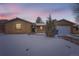 Charming single-story home with brick facade, attached garage, and snow-covered front yard at 12700 E Kentucky Pl, Aurora, CO 80012