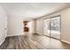 Spacious living area featuring gray flooring, sliding glass doors, and an adjacent kitchen at 12700 E Kentucky Pl, Aurora, CO 80012