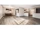 Open-concept living space with gray flooring, dining area, and an inviting entryway at 12700 E Kentucky Pl, Aurora, CO 80012
