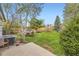 Lush backyard featuring a dining set and trampoline, providing a perfect outdoor retreat for relaxation and recreation at 13661 W Tufts Ave, Morrison, CO 80465