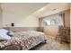 Comfortable bedroom featuring a bed, chair, and a window providing natural light at 13661 W Tufts Ave, Morrison, CO 80465