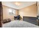 Neutral bedroom featuring a dresser, writing desk, and dark trunk at 13661 W Tufts Ave, Morrison, CO 80465