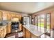 Well-lit kitchen with granite countertops, stainless steel appliances, and access to outdoor space at 13661 W Tufts Ave, Morrison, CO 80465