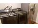 Convenient laundry featuring newer Samsung washer and dryer next to stainless steel refrigerator for modern living at 13661 W Tufts Ave, Morrison, CO 80465