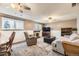 This living room has carpet, a fireplace, and a comfortable seating area with a TV at 13661 W Tufts Ave, Morrison, CO 80465