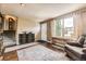 Open living room with hardwood floors, a comfortable chair, and ample natural light from a large window at 13661 W Tufts Ave, Morrison, CO 80465