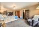 Relaxing main bedroom with neutral tones, carpet floors, a queen bed, and comfortable seating at 13661 W Tufts Ave, Morrison, CO 80465