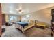 Spacious main bedroom features a comfortable bed, natural light, and cozy seating area at 13661 W Tufts Ave, Morrison, CO 80465